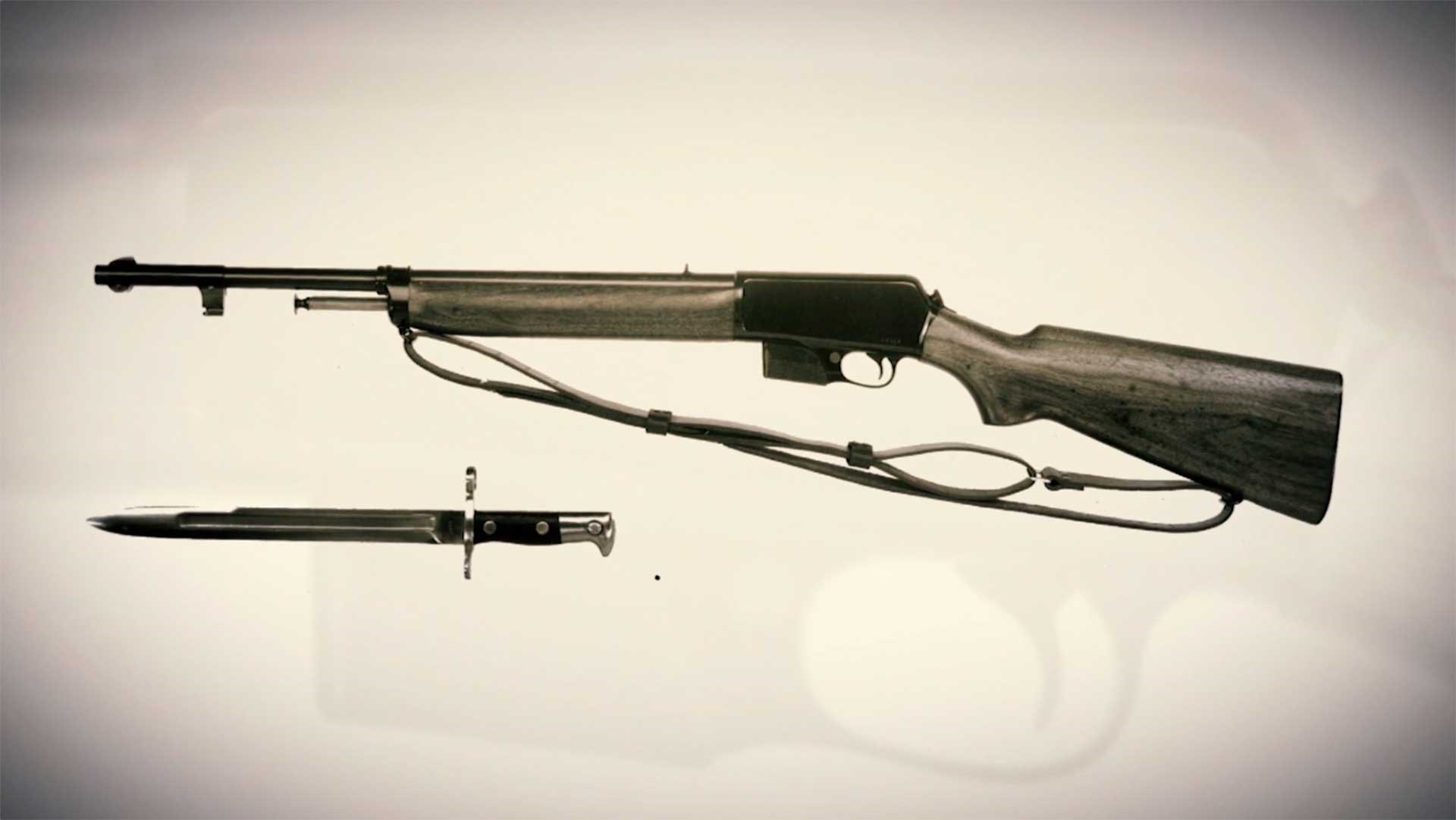 Left side of the Winchester Model 1907, along with a compatible bayonet.