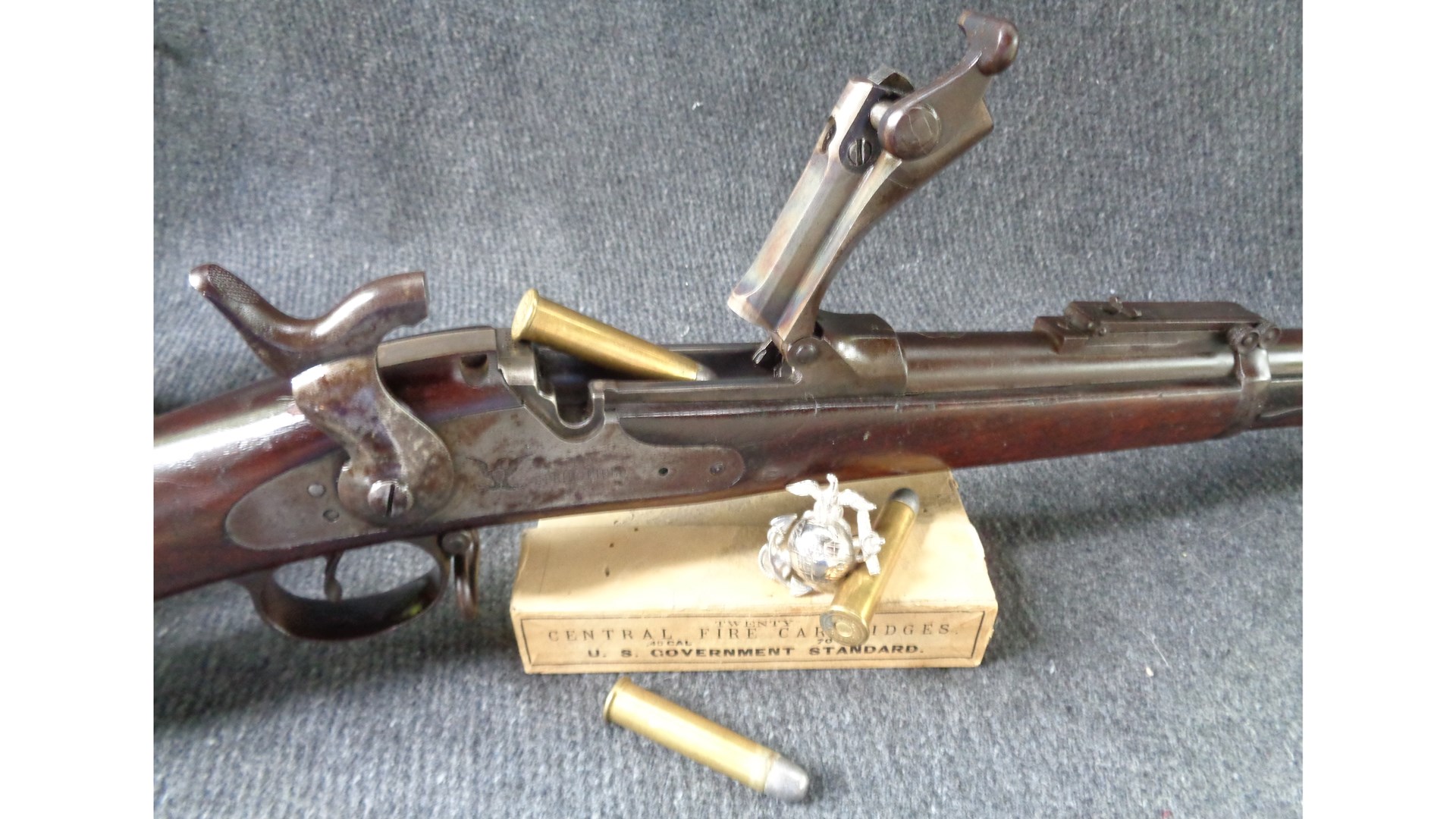 trapdoor springfield rifle action open cartridge ammo box marine medal