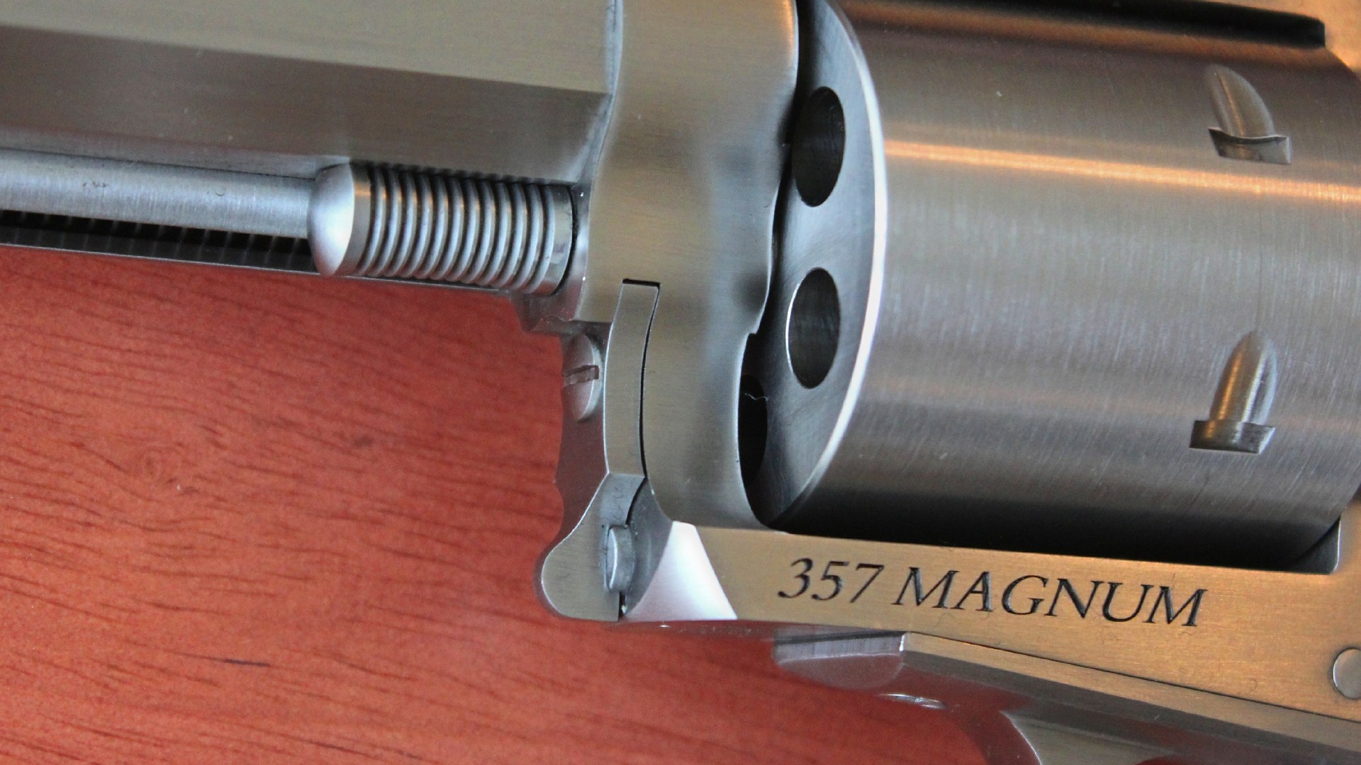 Left-side closeup stainless steel .357 Magnum engraving gun revolver cylinder Magnum Research BFR