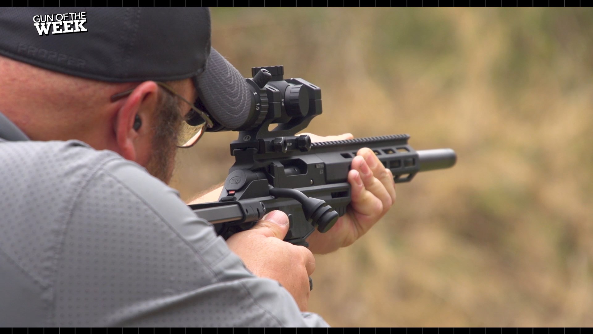 Man shooting CZ-USA 600 Trail rifle outdoors black gun ballcap glasses beard