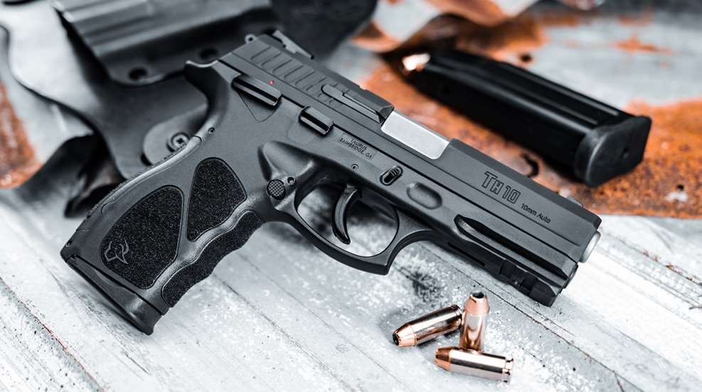 Taurus TH10 pistol black shown with magazine ammunition holster right-side view