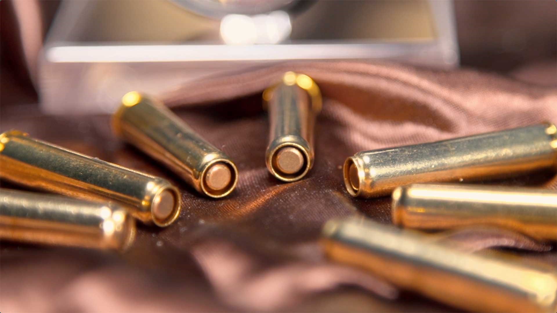 A collection of M1895 Nagant revolver cartridges laid out on a table.