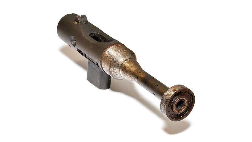 View of stripped Welrod receiver with magazine and barrel attached shown on white background