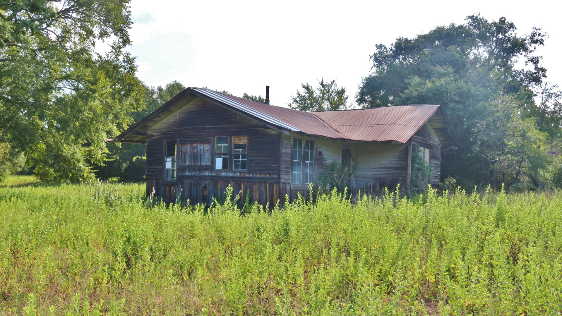 Sellmark Ranch whiskey cabin old house in field with trees