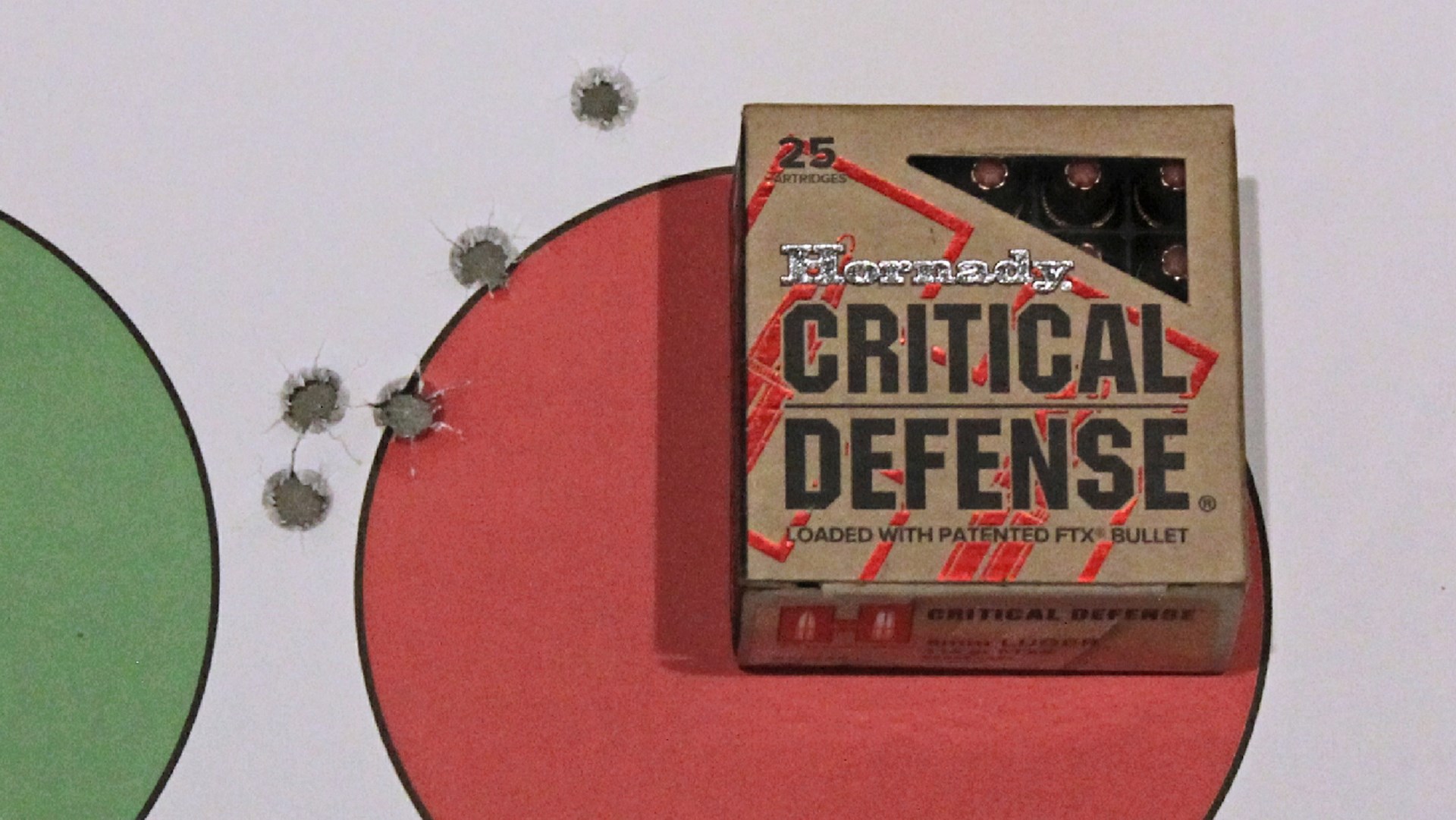 Centurion 14 accuracy group target with Hornady Critical Defense ammunition atop round red circle adjoining bullet holes