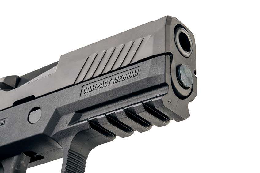 SIG Sauer P320 muzzle, front of slide and frame Picatinny rail shown on white.