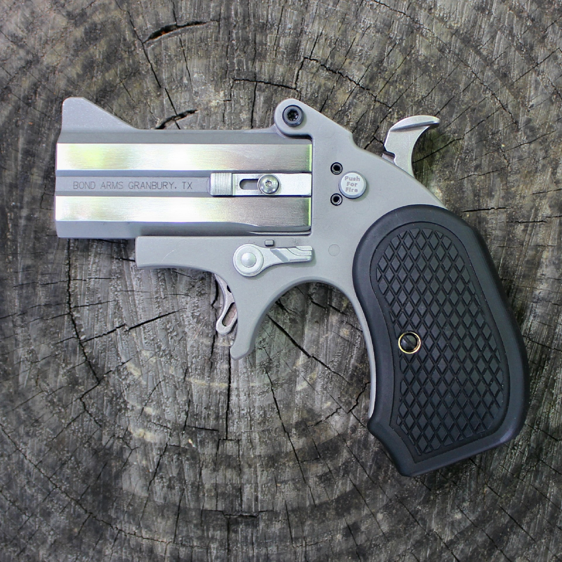 Custom two-shot derringer pistol build left-side view stainless steel gun barrels wood background