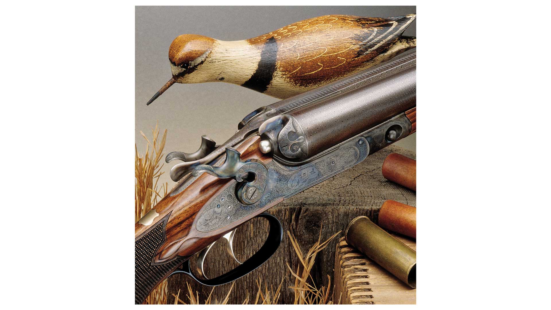 side-by-side shotgun right-side view on table with brass ammunition bird decoy