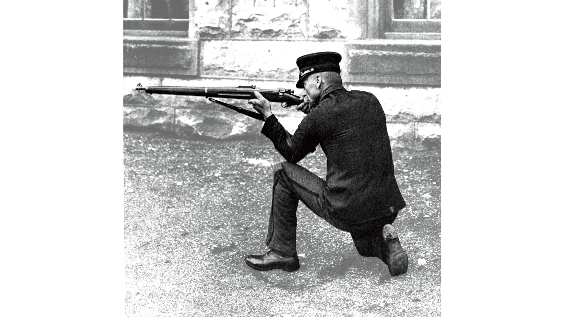 man shooting rifle kneeling position