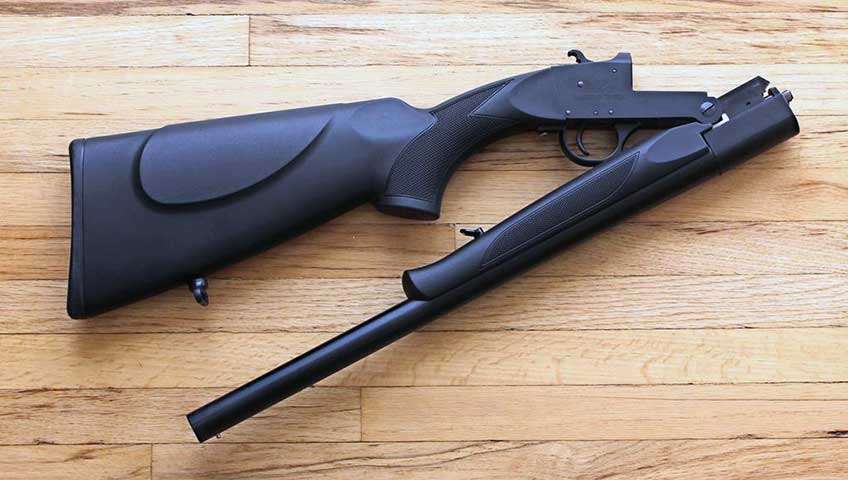 Nomad shotgun hinged open compact gun single-shot on wood floor