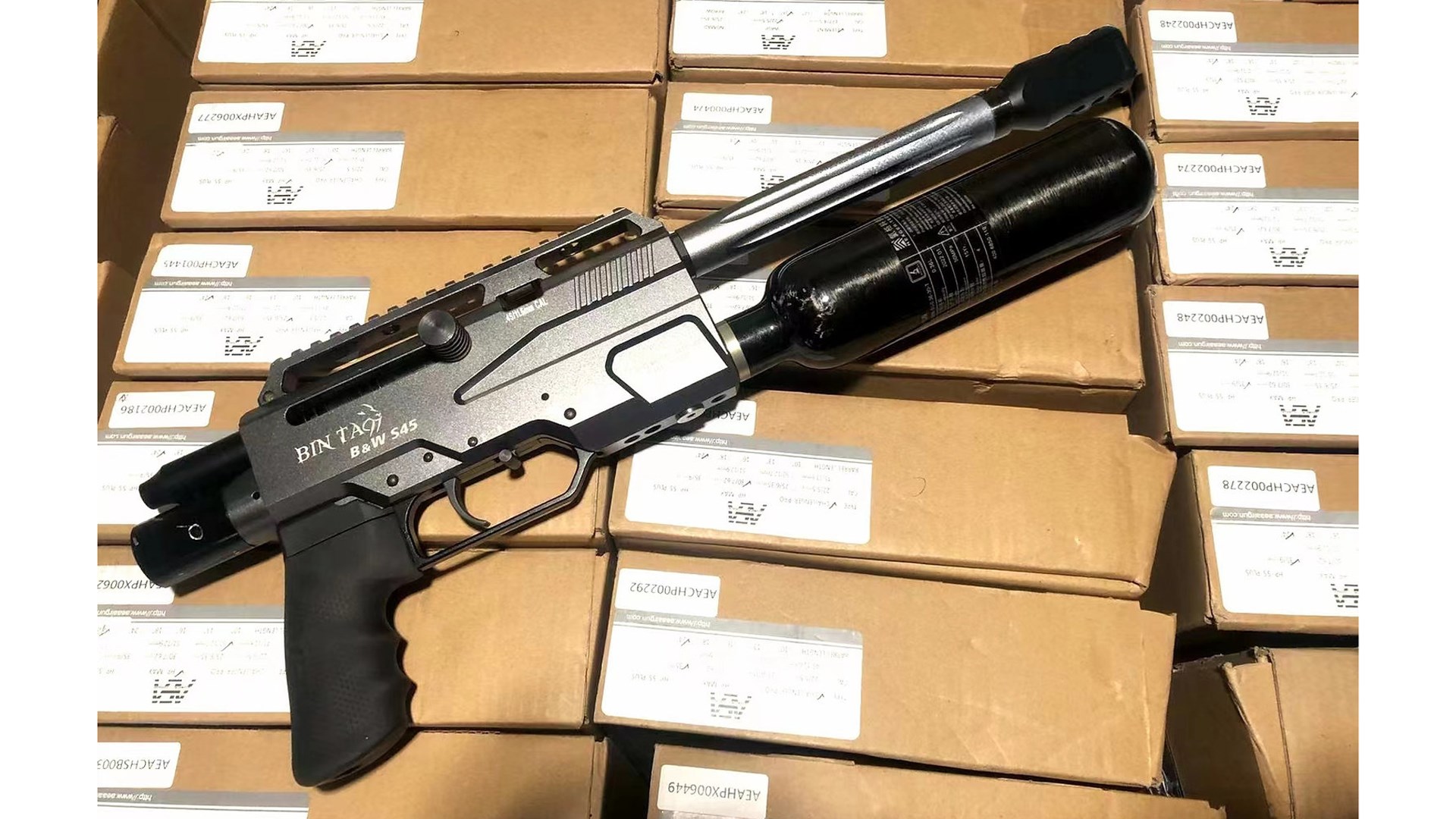 BinTac LLC S45 Mini PCP air pistol gun on boxes