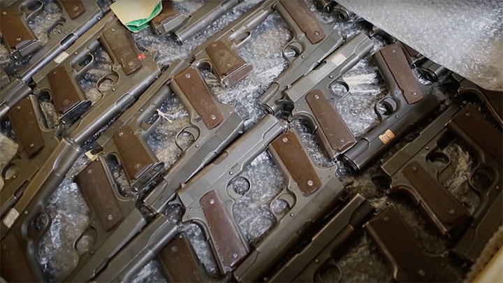 A look inside one of the army crates containing M1911 pistols.