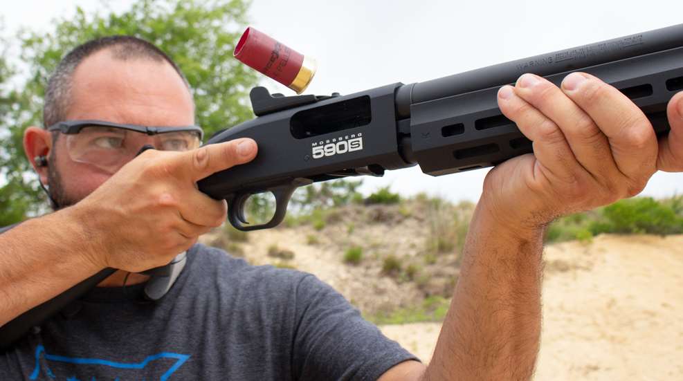 man shooting shotgun