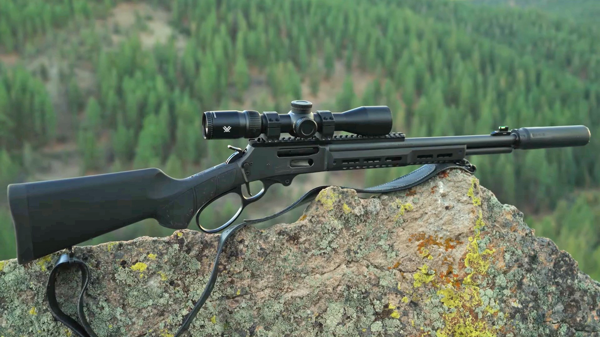 All-black Smith & Wesson Model 1854 lever-action rifle resting on a rock outcropping.