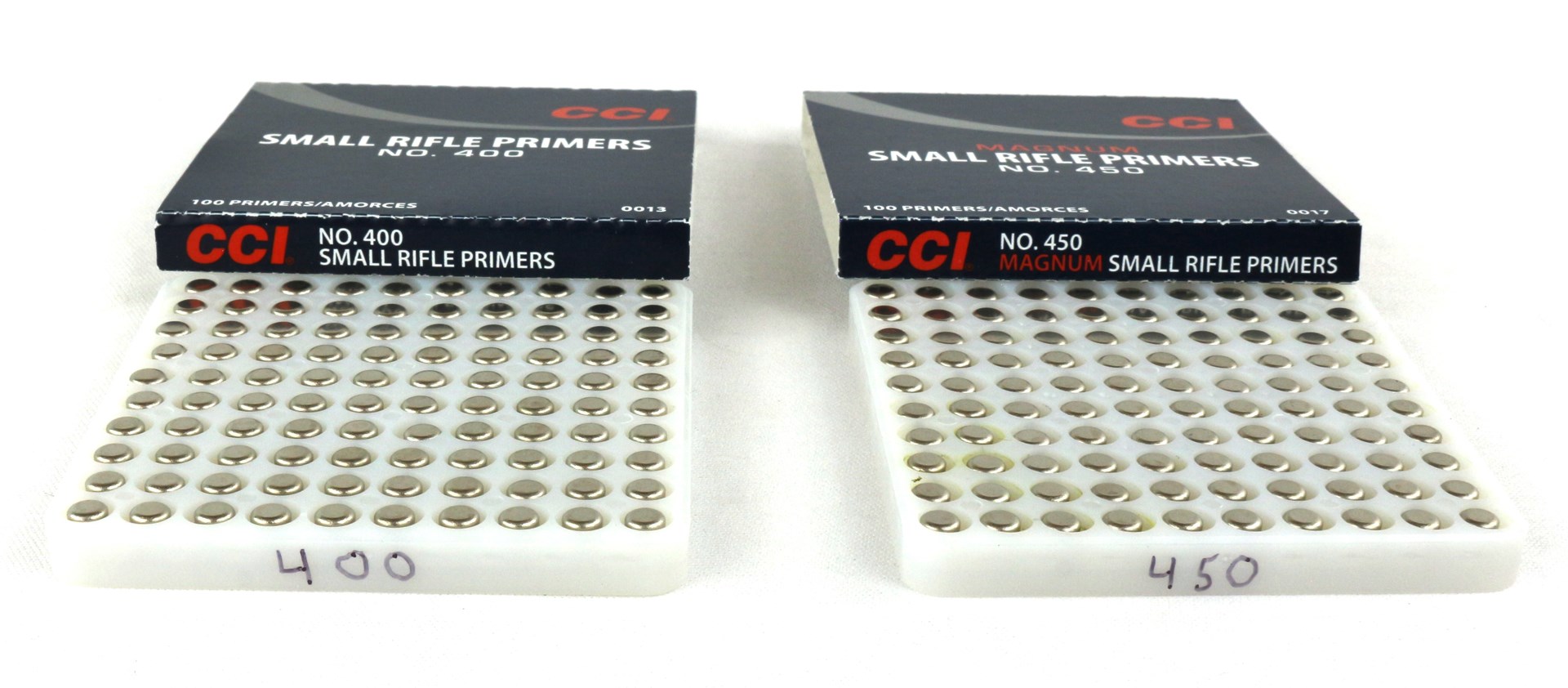 CCI No.400 and No.450 rifle primers tray boxing packaging on white labeled with sharpie bottom numbers circular holes ammunition component