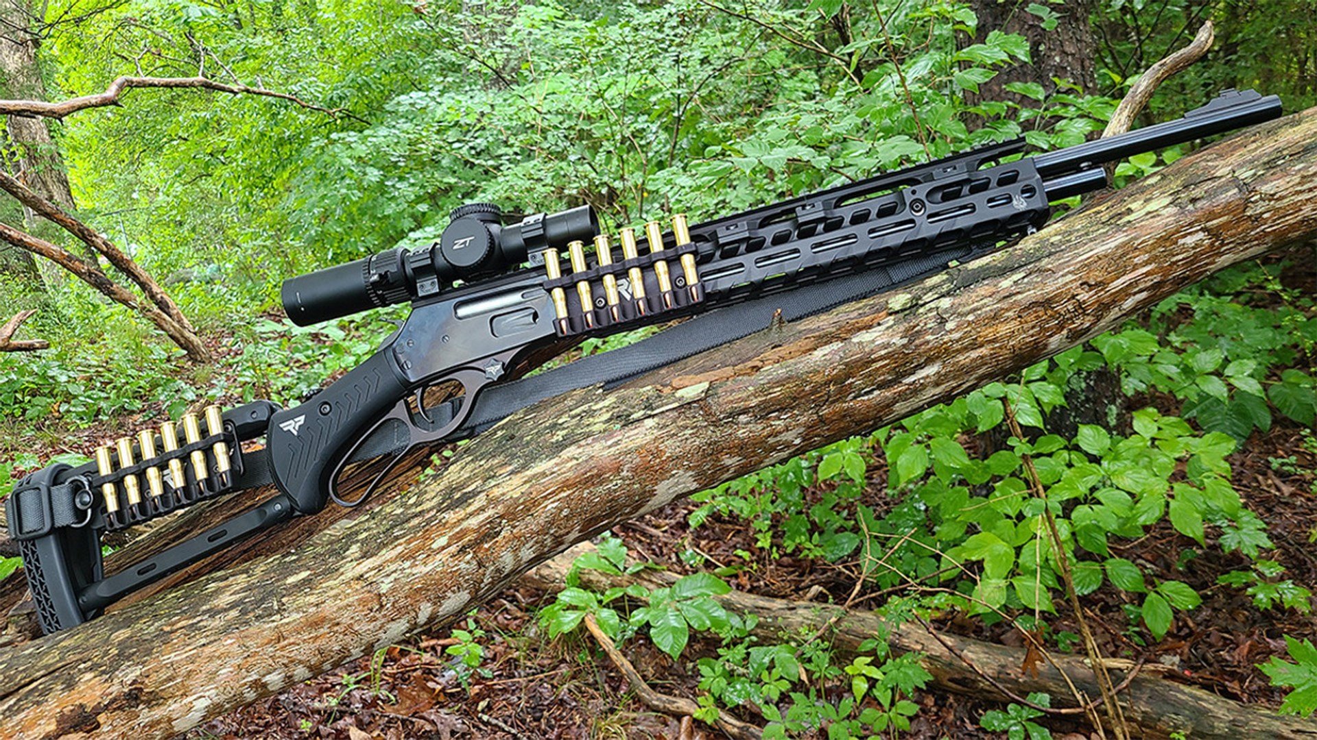 Rossi R95 lever-action rifle shown with tactical aftermarket accessories in the woods.