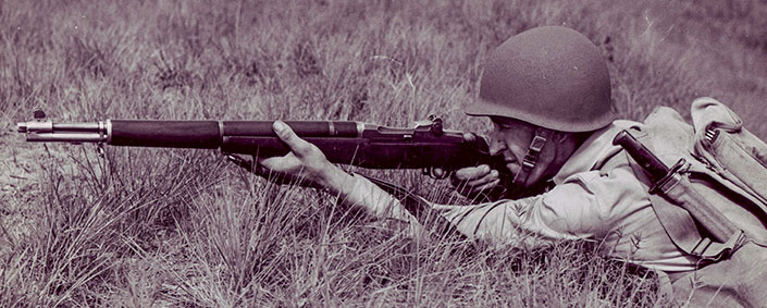 U.S. Army infantryman firing a gas trap M1 rifle