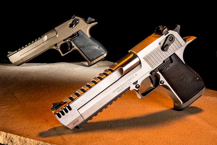 A stainless-steel Magnum Research Desert Eagle sits in the foreground while a tan-Cerakote Desert Eagle rests in the background.