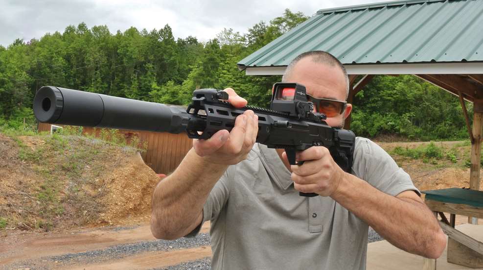 Author Frank Melloni shown here on the shooting range outdoors with Ruger LC Carbine in .45 ACP with suppressor attached
