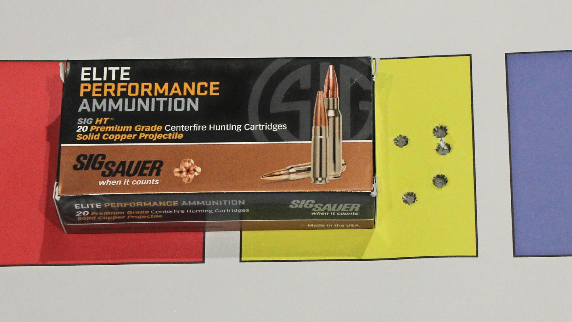 SIG Sauer Elite Performance Ammunition box shown with target accuracy group holes in yellow square