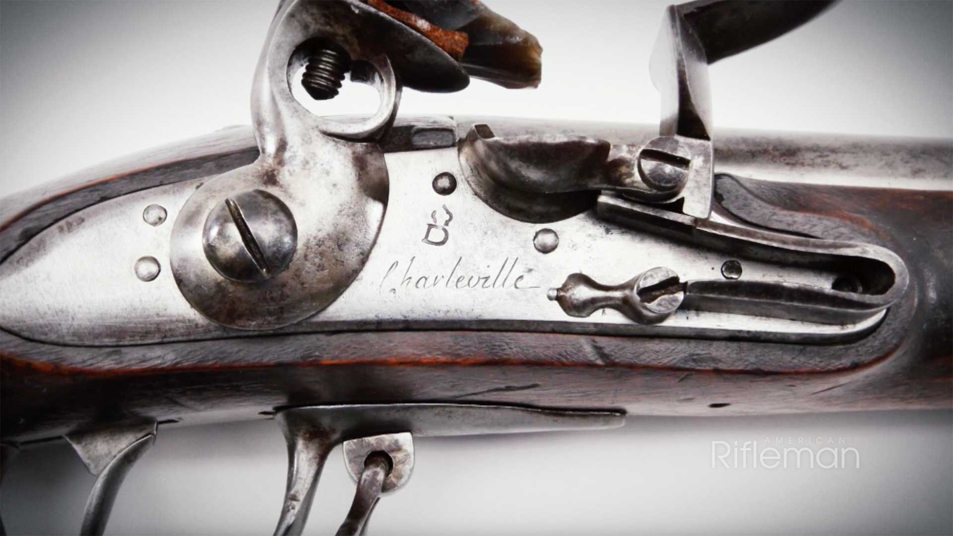 Charleville markings on a flintlock musket lock.