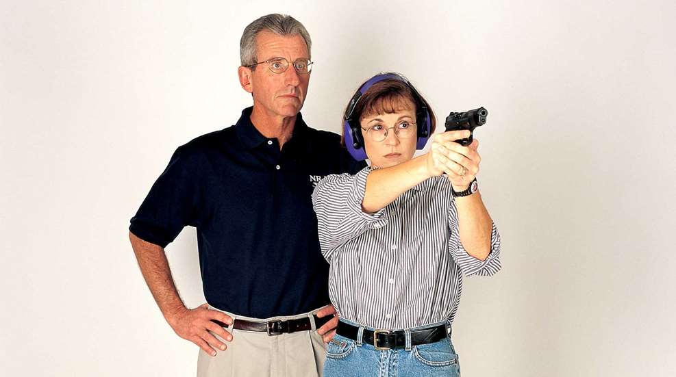 Man woman training weaver handgun stance