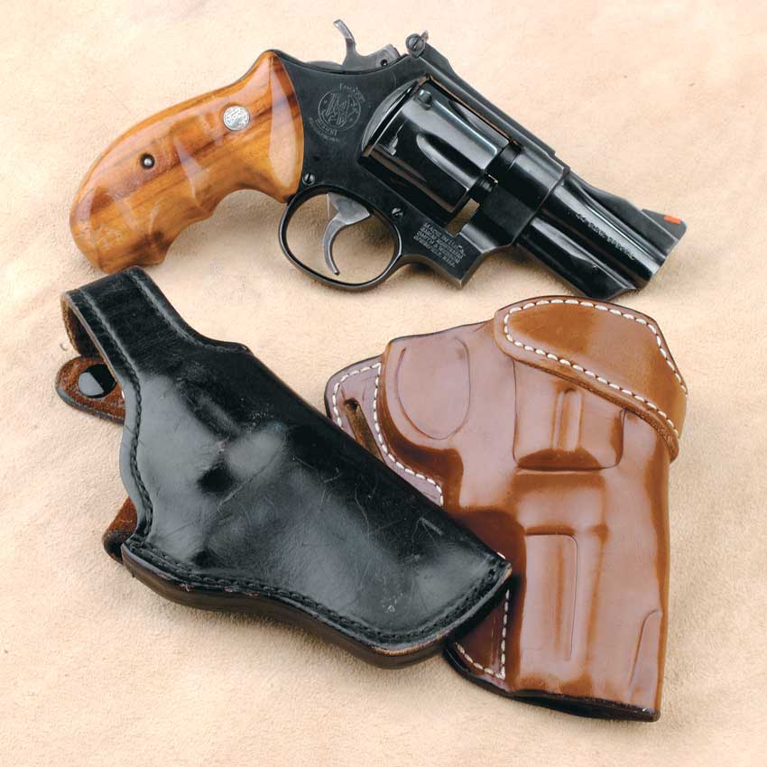 revolver gun blued steel metal wood grips leather holster brown black arrangement