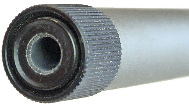 Silver barrel on white backround showing muzzle with black thread protector.