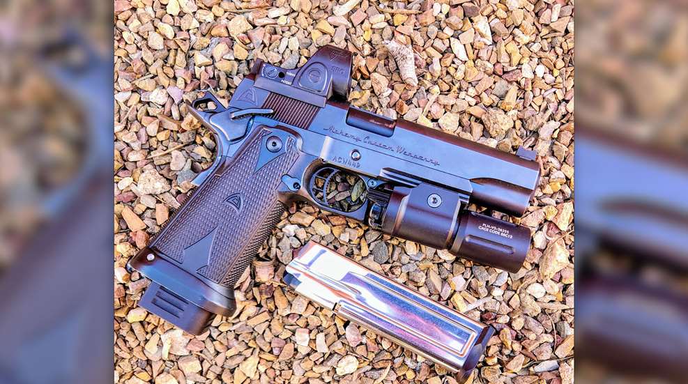 Alchemy Custom Weaponry Quantico HiCap handgun right-side view on gravel image overlay