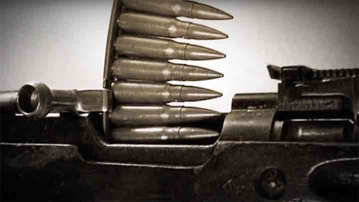 A 10-round stripper clip loading into the magazine of the SKS-45.