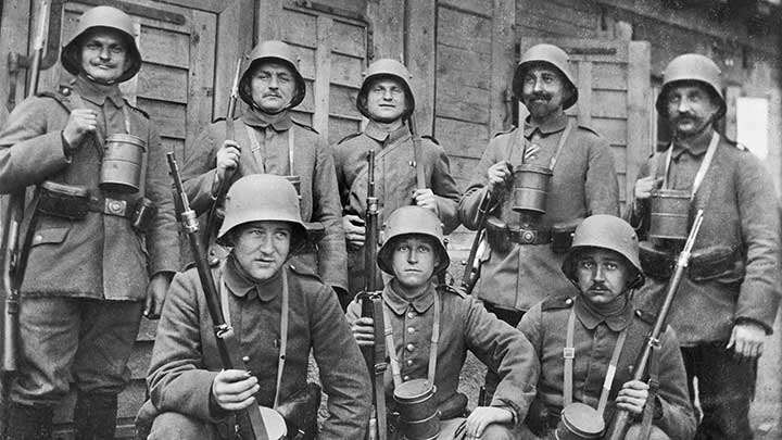 German soldier posing for a photograph with their Gew 98 rifles visible.