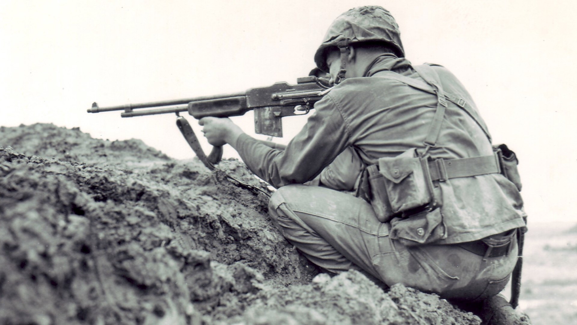U.S. marine nestled in rocks Okinawa Hill in spring 1945