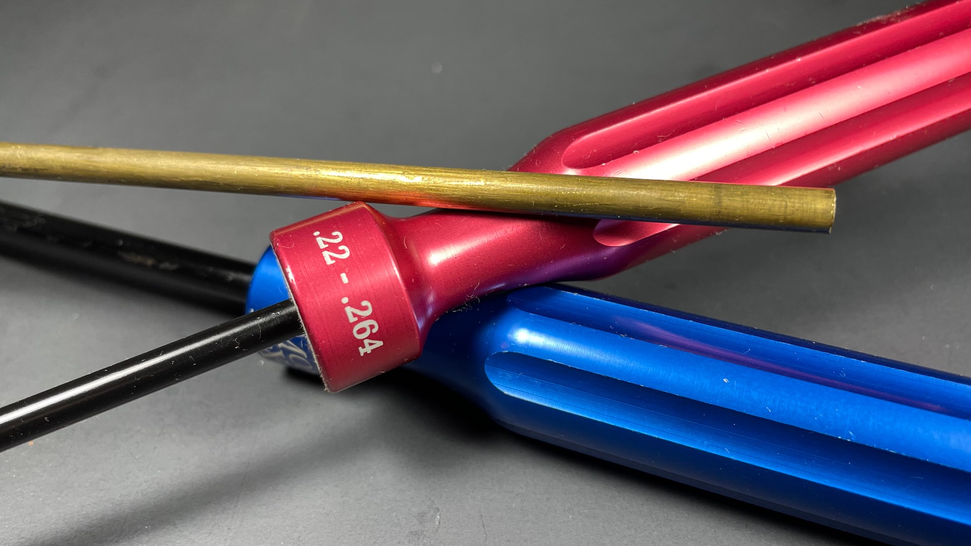 three cleaning rods red blue handle brass rod