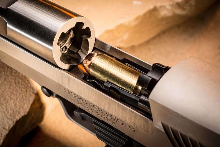 Slide of the Magnum Research Desert Eagle locked back, showing a loaded magazine inserted with a .50 AE round pointing at the chamber, ready to load.