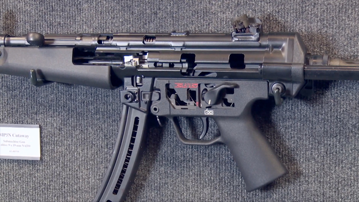 MP5N cutaway mounted on a gray wall.