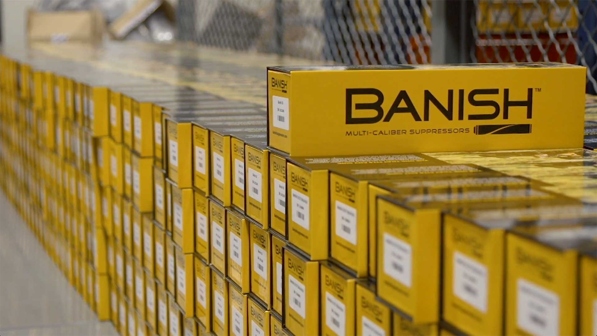 A stack of yellow suppressor boxes inside a caged room.