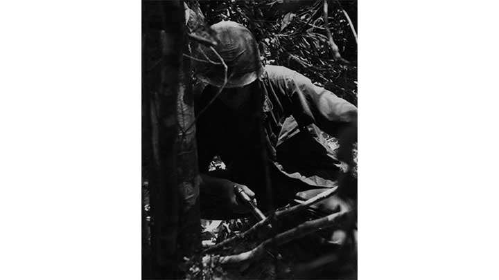 A leatherneck of the 3rd Marine Division checking a VC bunker in July. 1968.
