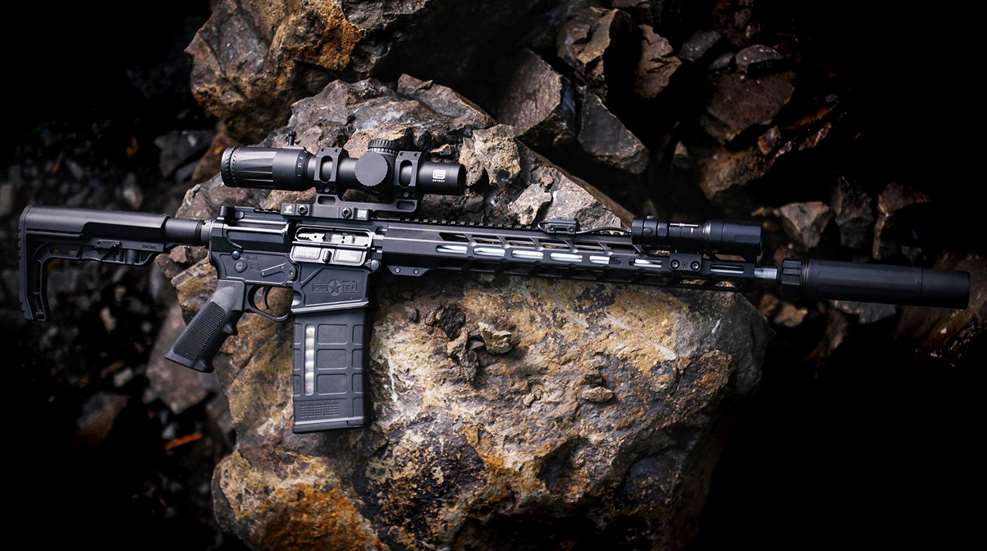 Patriot Ordnance Factory BASE rifle LMR right-side view on rock with accessories optic flashlight suppressor