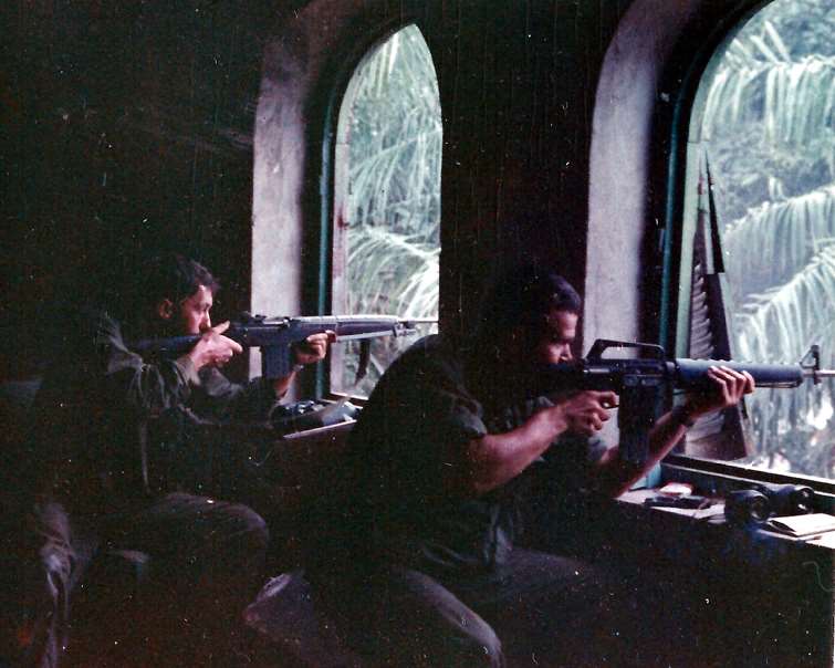 Marines equipped with M14 and M16 rifles engage Viet Cong snipers during the battle for Hue, Feb. 1968.