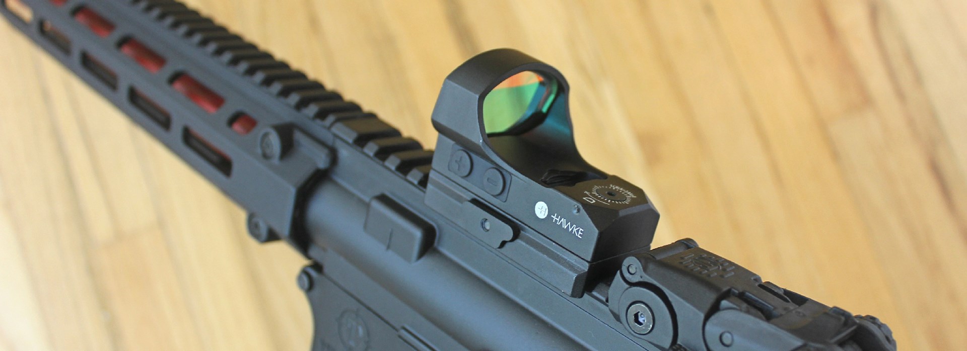 Hawke red-dot optic mounted on AR-15 Picatinny rail receiver gun rifle