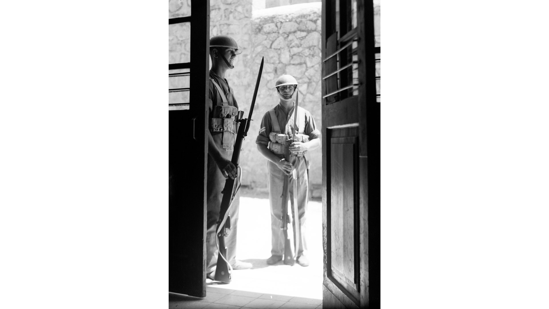 Securing the vestiges of their empire, British troops guard the entrance to a post office in Jerusalem during the 1936 Arab Revolt.  Short Magazine Lee-Enfield No. 1 Mk. III rifles equipped with the Sword Bayonet, Pattern 1907.