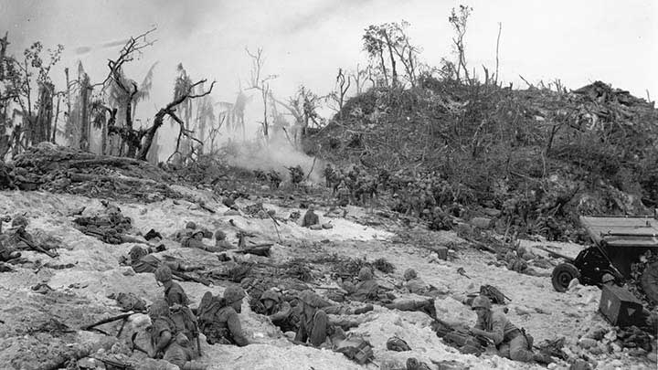 A view of “White Beach 2” showing the spot where F Company, 1st Marines landed on Sept. 15, 1944. The smoke that can be seen at rising at center left is from a white phosphorous smoke grenade that was used against a Japanese bunker located there. Note the 37 mm M3 anti-tank gun at far right.