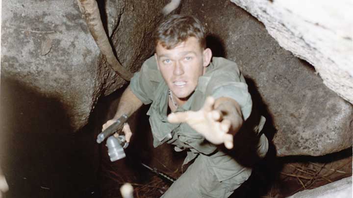 One way out: A GI of the 1st Cavalry Division, with M1911 and flashlight in hand, looks for a helping hand out of a VC tunnel complex during Operation Pershing in March, 1967.