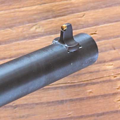 The front sight with a brass bead at the tip.