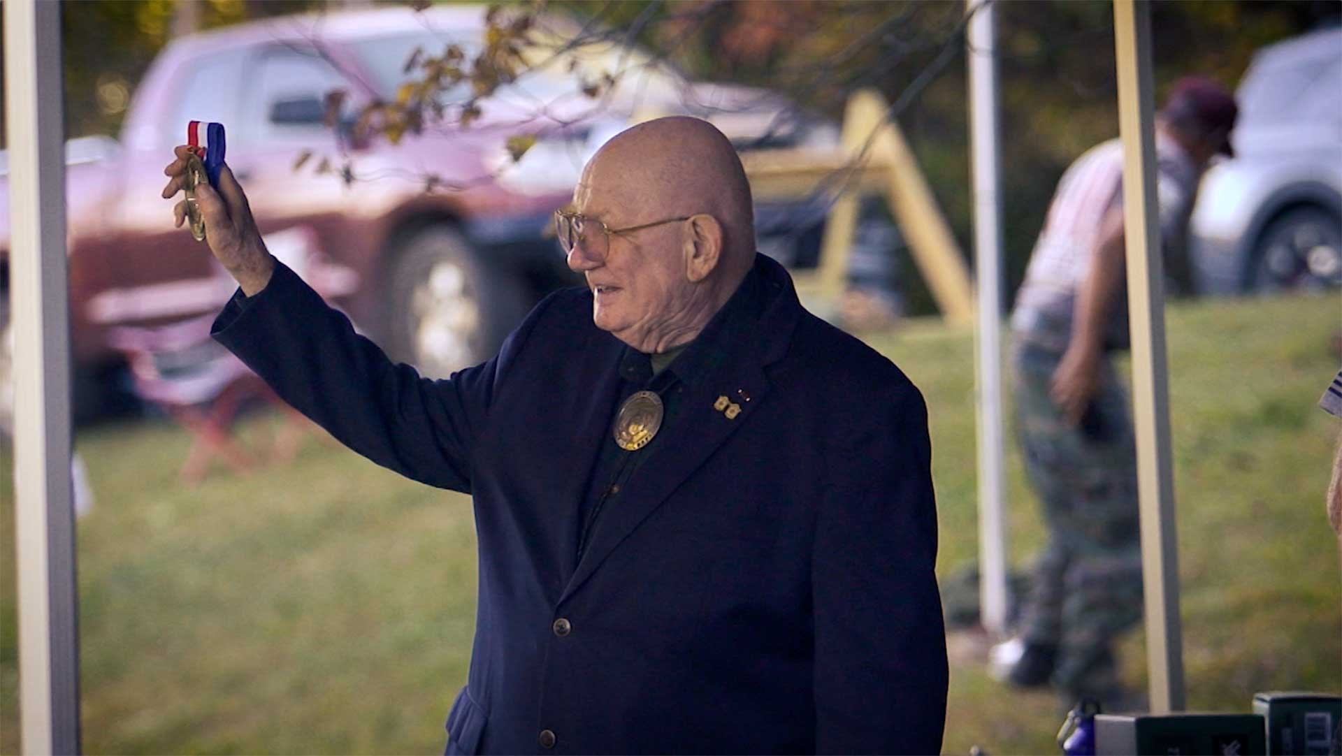 Major Jim Land holds up a prize medal at the Major Land Sniper Cup in Gladstone, Virginia