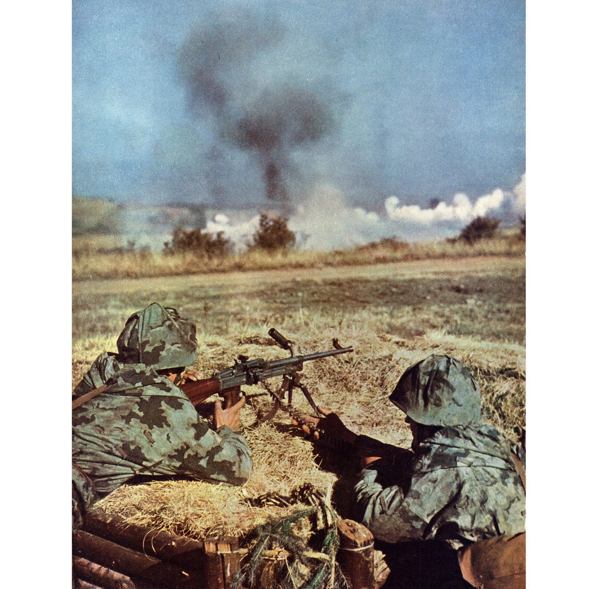 A Czech machine gunner and assistant gunner operating a vz. 52/57 light machine gun during a field training exercise during the 1960s.