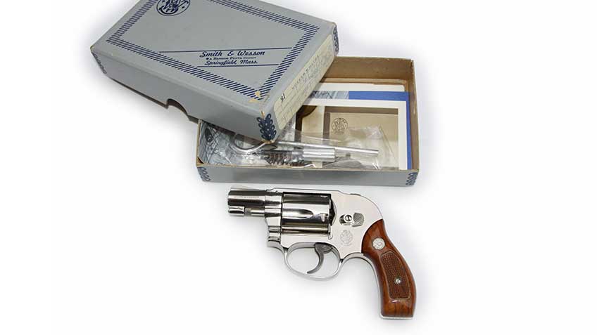 Smith &amp; Wesson Model 49 Bodyguard shown on white, along with its original box and manual.