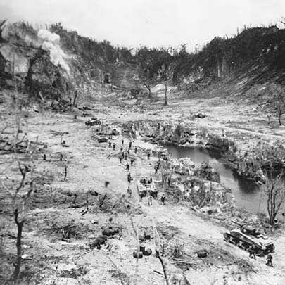 Sherman medium tanks from the 1st and 3rd platoons of A Company, 710th Tank Battalion moving into Peleliu’s Mortimer Valley past Grinlinton Pond on Oct. 7, 1944. (U.S. Marine Corps photograph #97433).
