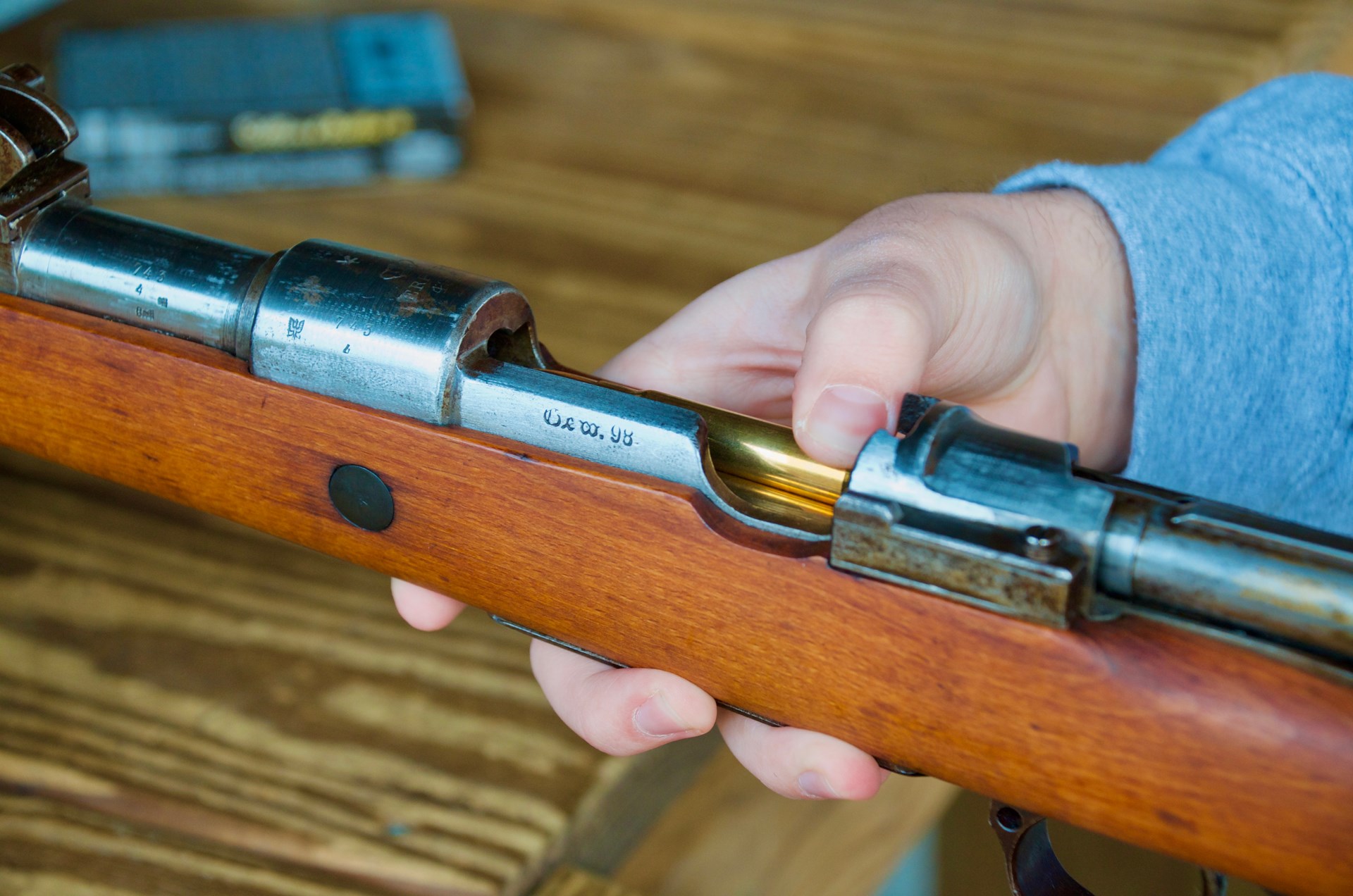 fingers loading ammunition in mauser 98 gewehr rifle bolt-action military surplus collector item