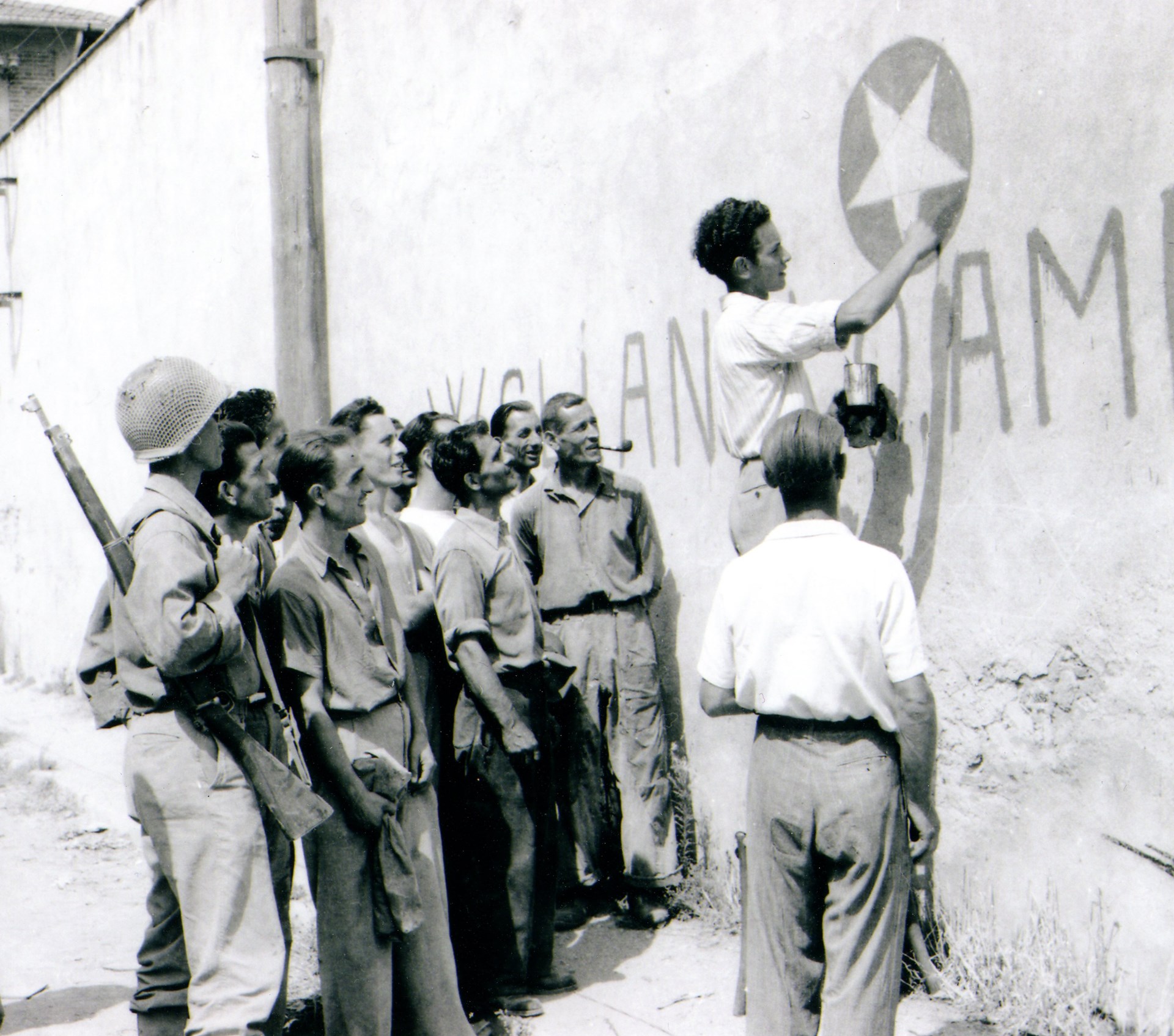 Sicilian civilians welcoming US troops during late July 1943. The dusty GI carries a classic M1903 Springfield rifle. NARA
